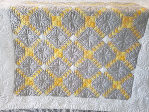 gray and yellow quilt