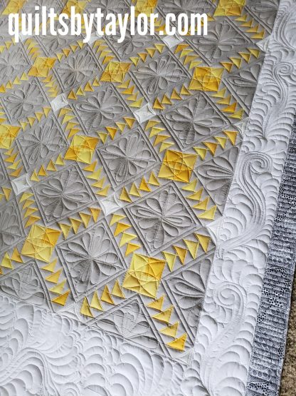 gray and yellow quilt